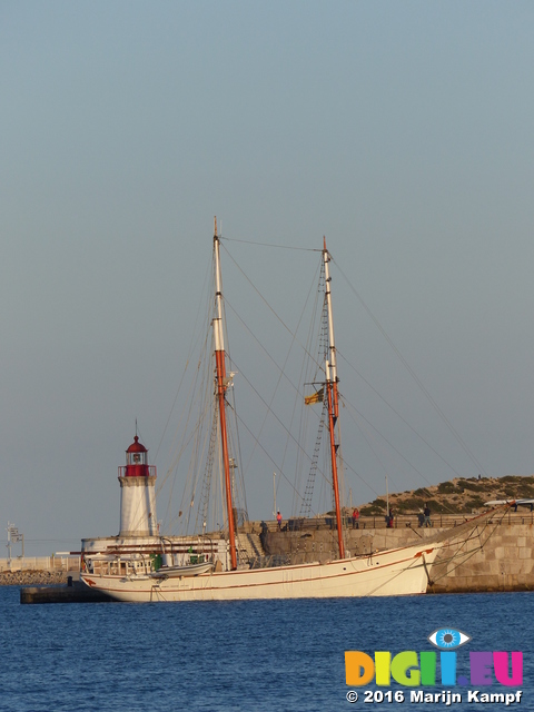 FZ027440 Old sailboat by lighthouse